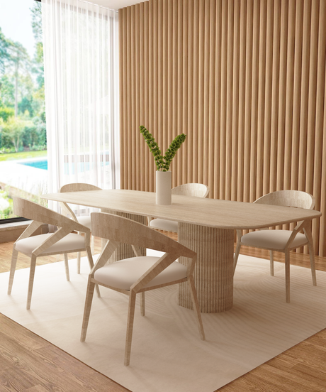 A light stone oval table with two cylindrical, fluted pedestal legs, set against a plain white background.