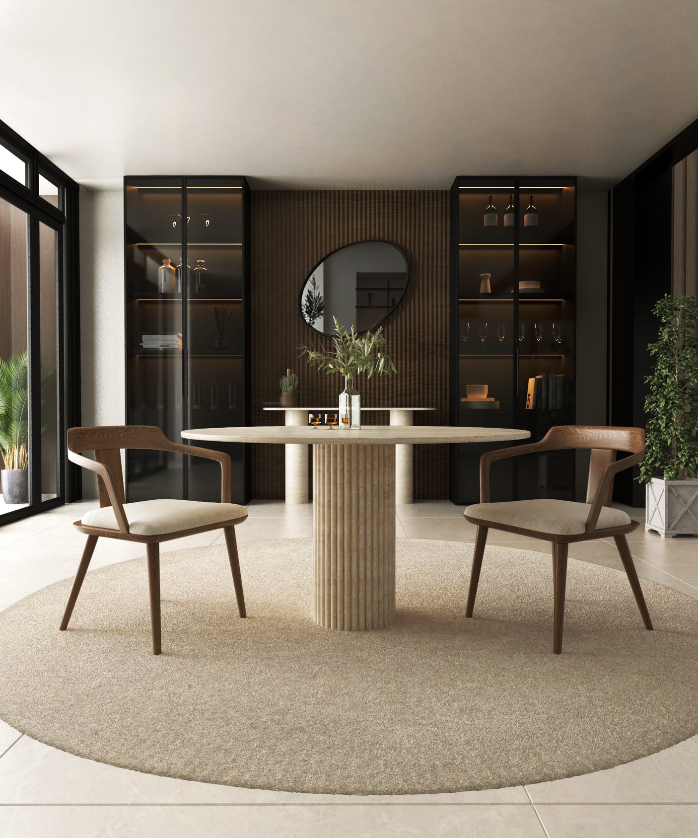 A modern dining room with natural elegance centers on the TRAVERTABLE Oval Travertine Dining Table with Fluted Round Base, paired with two wooden chairs, a beige rug, built-in shelves, round mirror, potted plants, and large windows.
