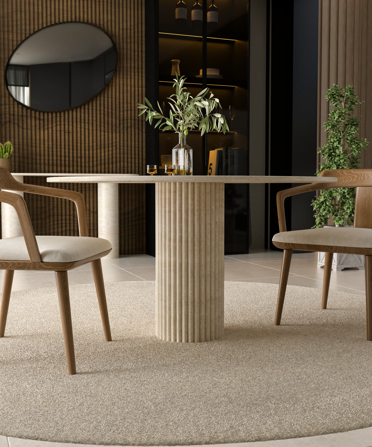 A TRAVERTABLE Oval Travertine Dining Table with Fluted Round Center Base is centered on a beige rug, flanked by two wooden chairs with light cushions. A glass vase with olive branches and glasses add elegance; modern decor and plants complete the look.