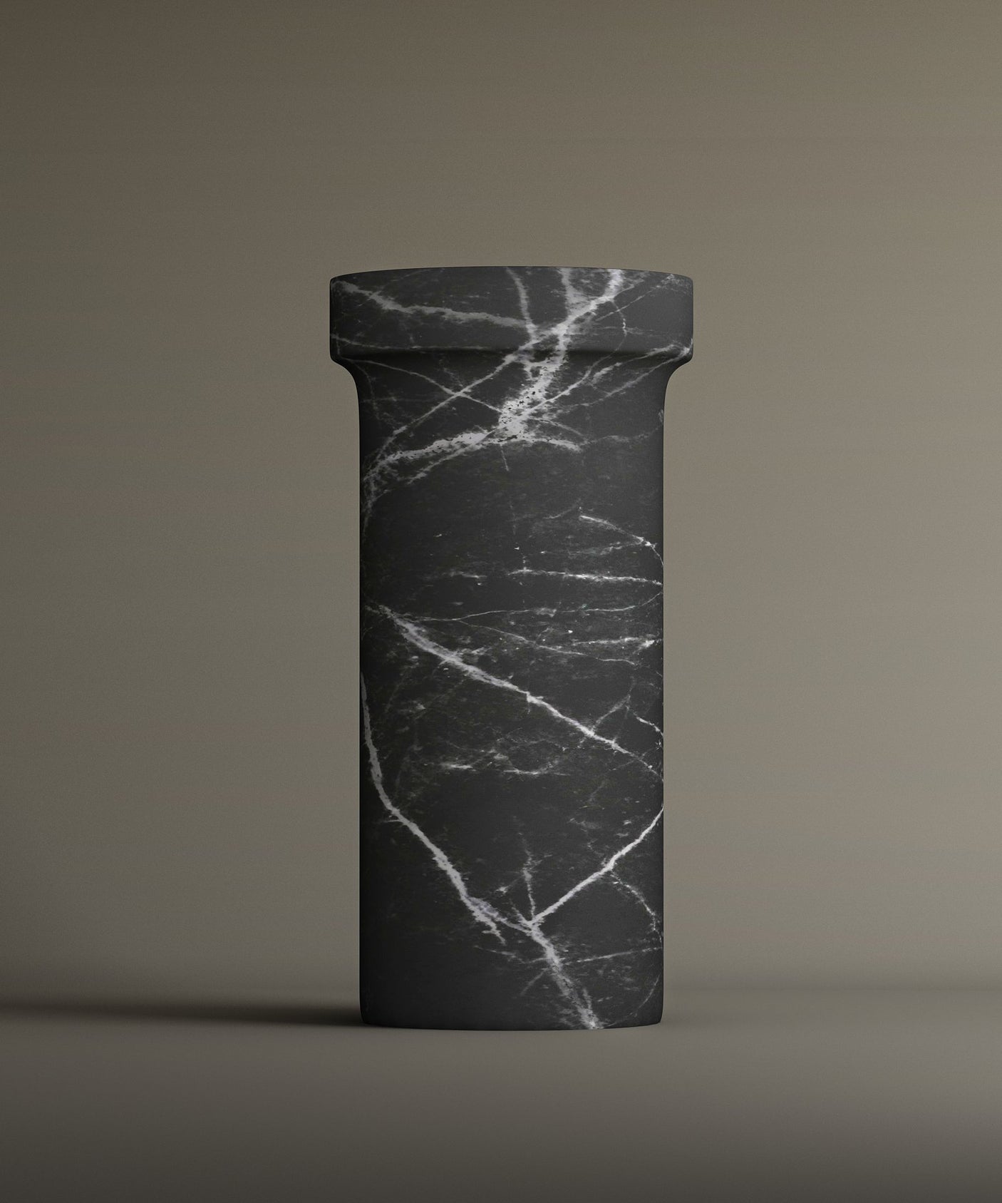 The TRAVERTABLE Nero Marquina Marble Pedestal Vanity Sink features a tall, cylindrical design with a round top and bold white veining—an elegant, freestanding piece that complements modern interiors.