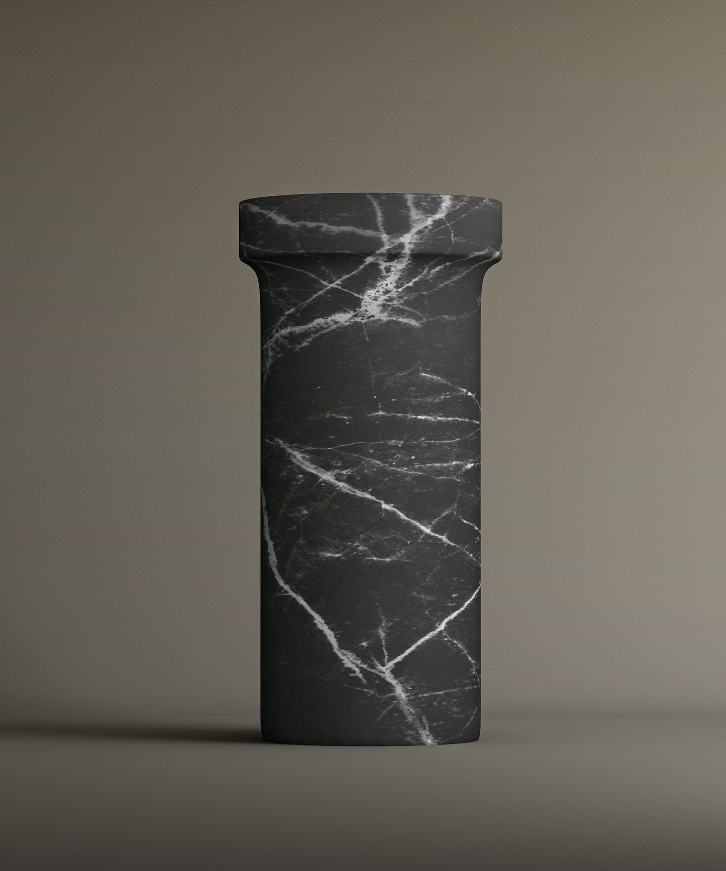 The TRAVERTABLE Nero Marquina Marble Pedestal Vanity Sink features a tall, cylindrical design with a round top and bold white veiningβan elegant, freestanding piece that complements modern interiors.