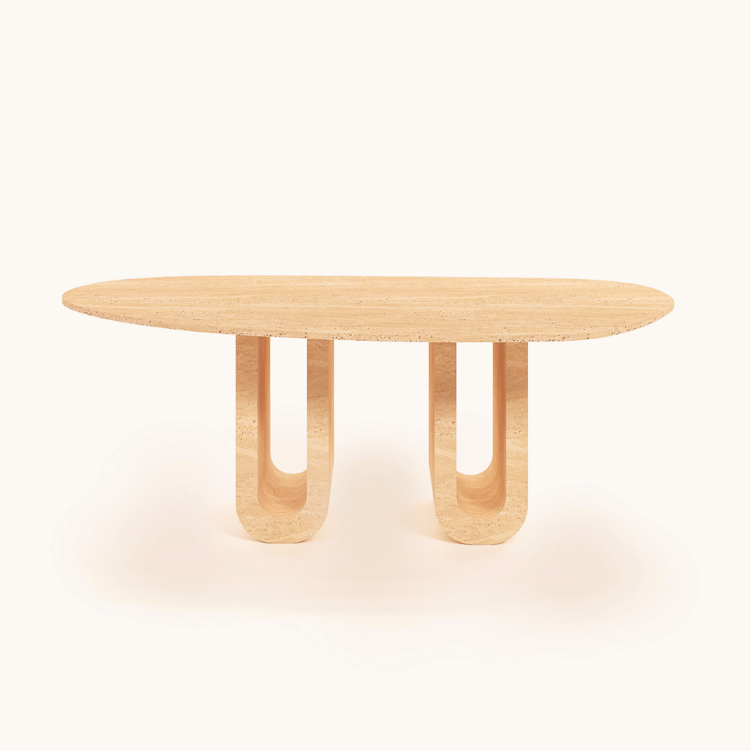 The Luxurious Oval Travertine Dining Table by Travertable boasts an elongated oval top with sleek dual columns and a light, natural wood finish for elegant aesthetics.