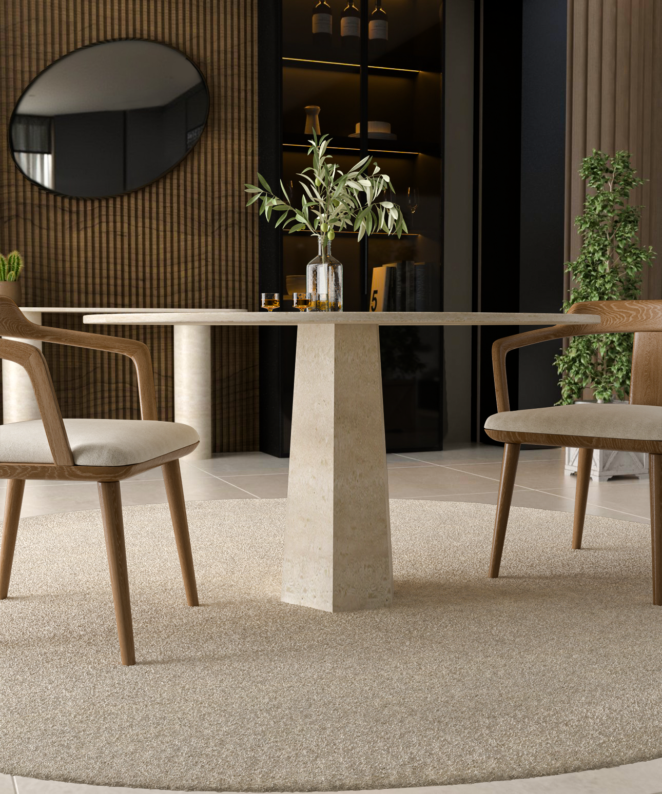 The TRAVERTABLE Oval Travertine Dining Table with a Rockcone center base and stone top is set with a glass vase and greenery. Two wooden chairs with beige cushions sit on a circular beige rug in a modern, minimalist room.