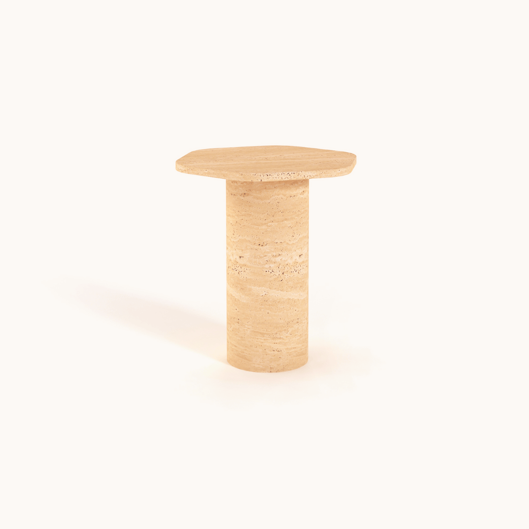The Travertable Natural Beauty Travertine Side Table, with its hexagonal surface and cylindrical base, showcases earthy elegance. Handcrafted from natural stone in beige, the textured table adds minimalist sophistication against a plain white background.