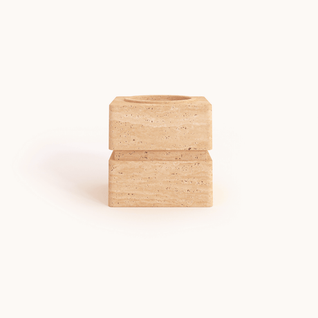 The Vintage Charm Travertine Vase by Travertable is a minimalist, cubic beige travertine object with a hollowed top, set against a plain white background.
