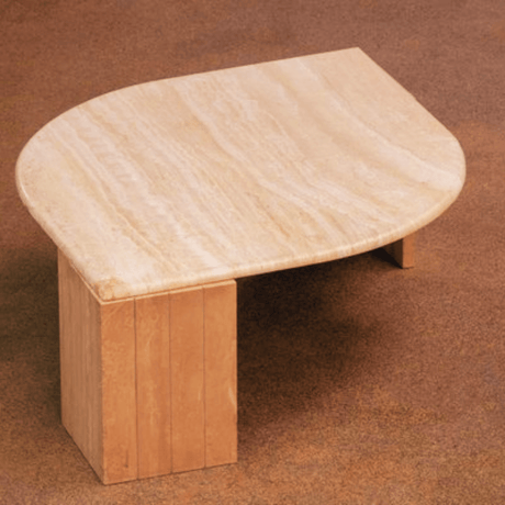 The Travertine Grace Coffee Table from Travertable features a smooth polished Italian travertine surface with elegant design. Its light natural tones complement the brown carpet, emphasizing timeless beauty.