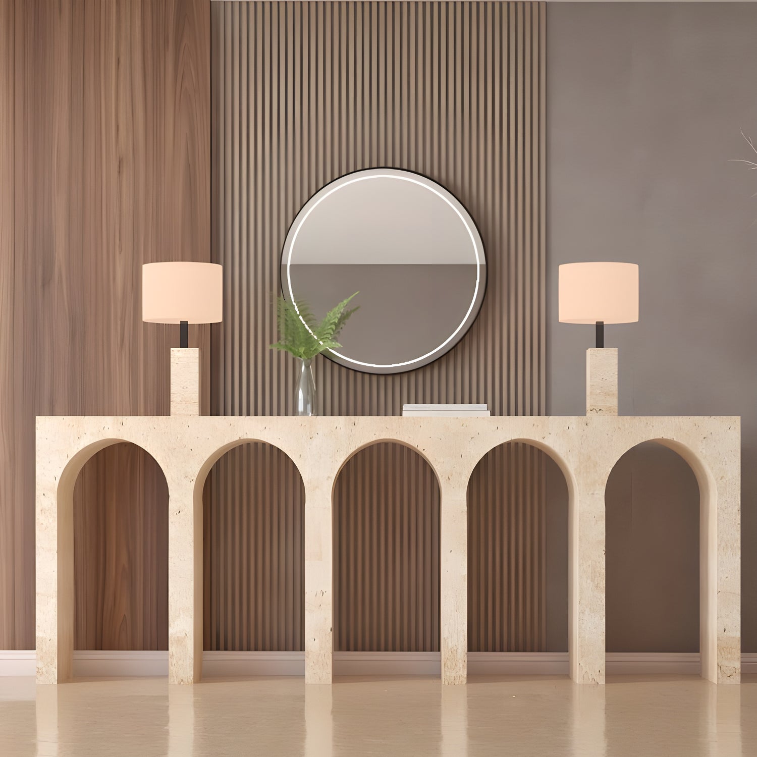 The TRAVERTABLE Travertine Console Table with Five Arches, topped with modern lamps, a round mirror, book, and glass vase of green leaves, brings understated luxury to wood paneling and gray accents.