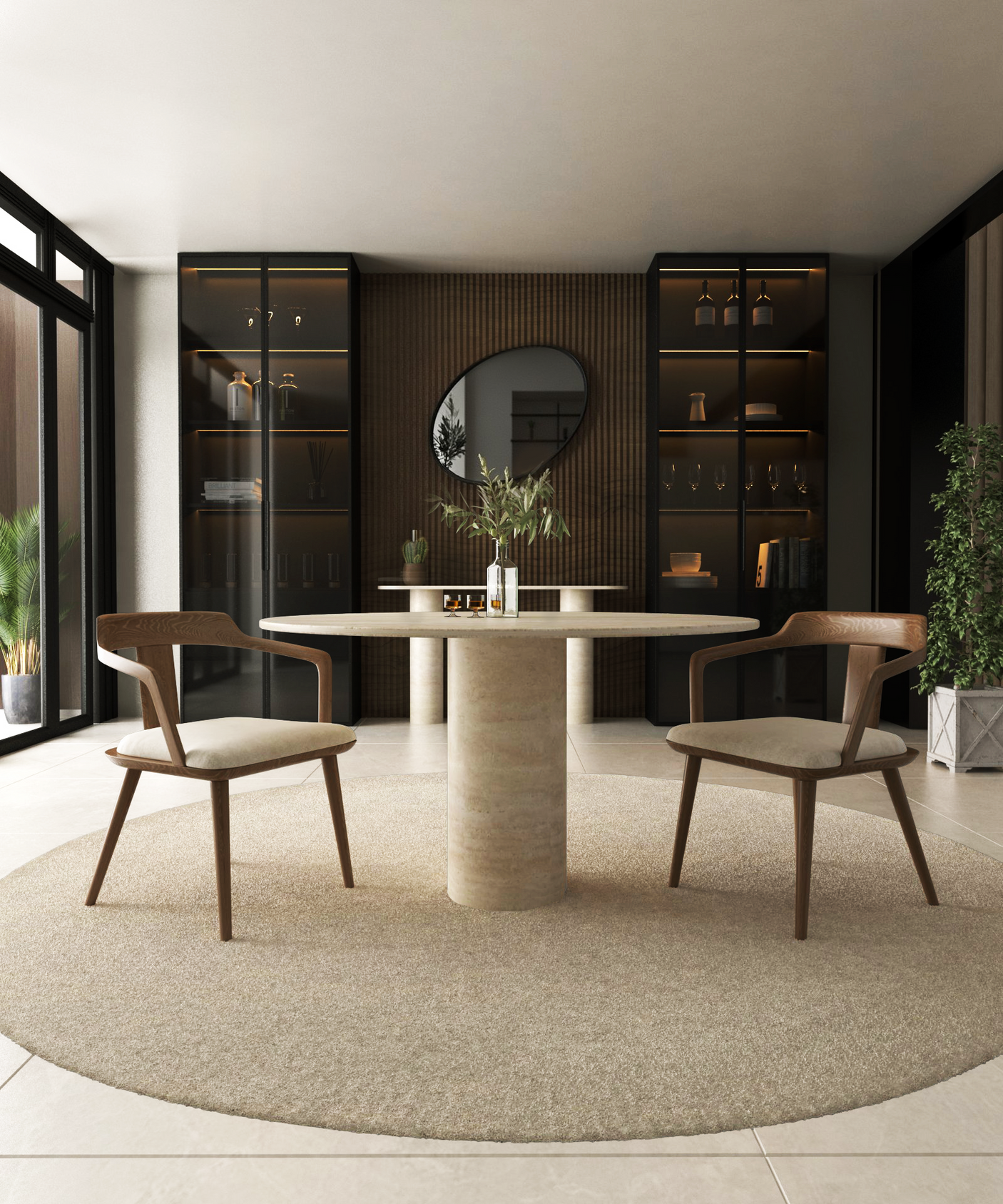 A modern dining space showcases the TRAVERTABLE Oval Travertine Dining Table with a cylindrical center base, paired with two wooden chairs on a beige rug. Shelves, a round mirror, and plants accent the room while sunlight streams through large windows.
