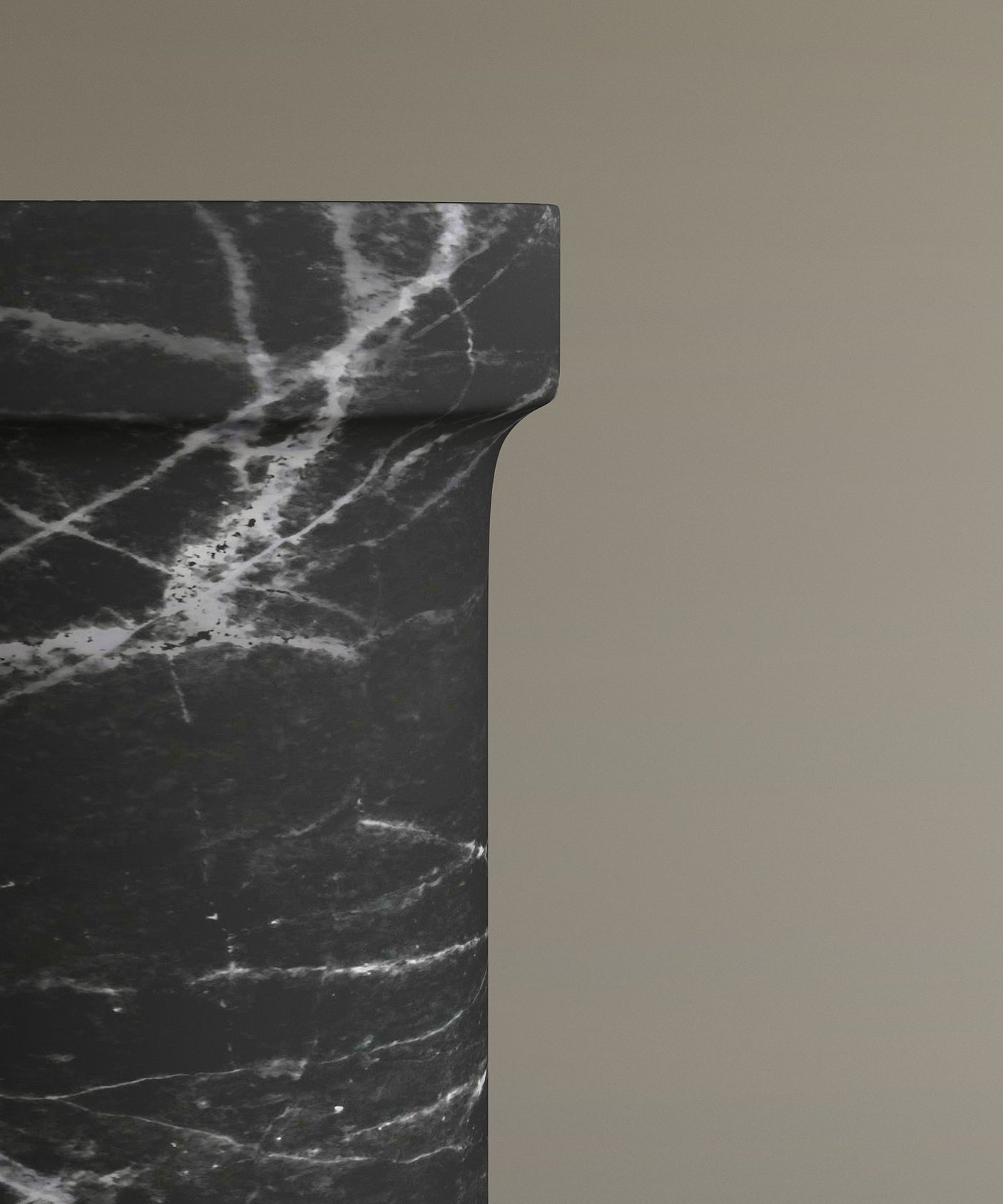 A close-up of the upper Nero Marquina Marble Pedestal Vanity Sink by TRAVERTABLE showcases white veining against a beige backdrop. This striking freestanding sink, partially seen on the left, is perfect for modern interiors.
