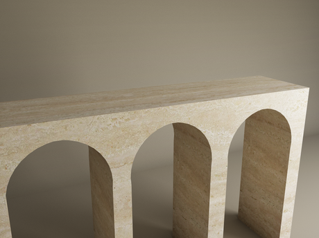 The TRAVERTABLE Travertine Console Table features four elegant arches and refined craftsmanship in beige stone, creating a sculptural statement against a neutral backdrop. This architectural console is fully customizable.