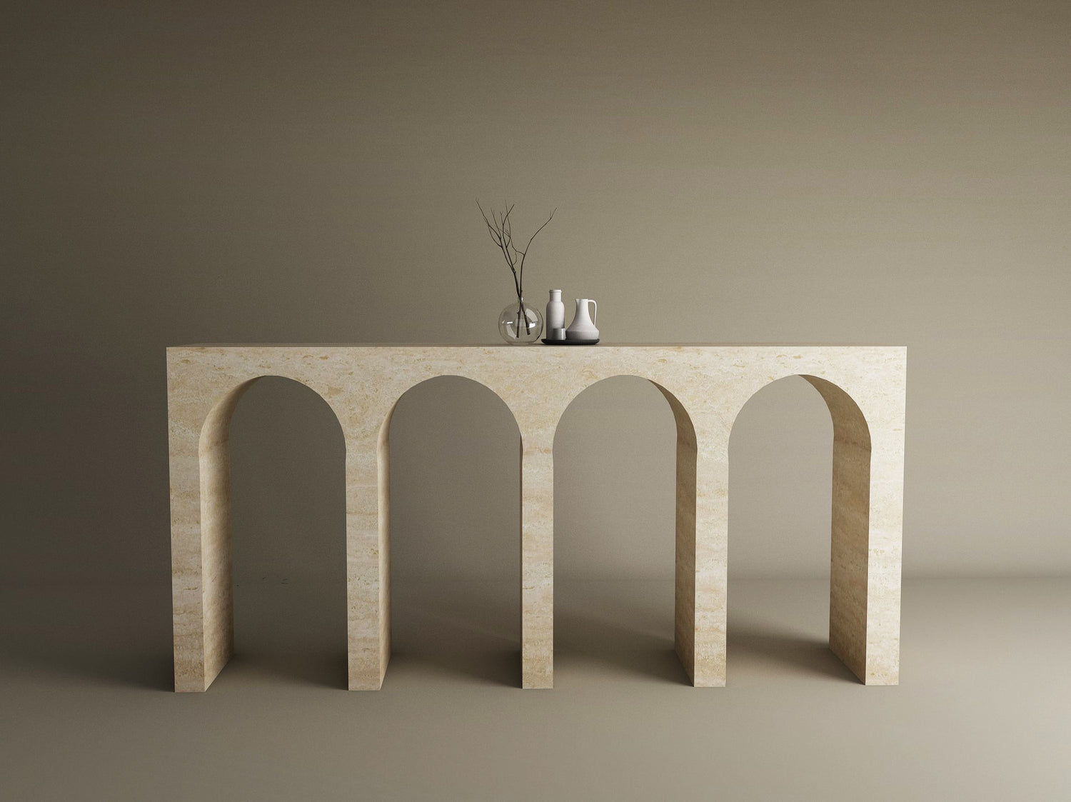 The TRAVERTABLE Travertine Console Table with Four Arches stands against a beige wall, highlighting sculptural elegance. Three minimalist decor pieces on top complete this refined display of the customizable Architectural Stone Console.