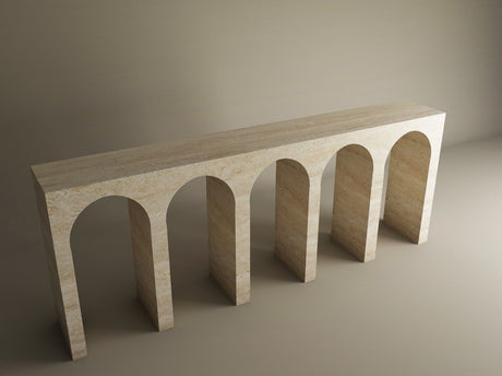 The TRAVERTABLE Travertine Console Table with Five Arches is a grand architectural statement, featuring minimalist beige stone arches, customizable to suit your space—an understated luxury piece beautifully showcased with soft lighting.