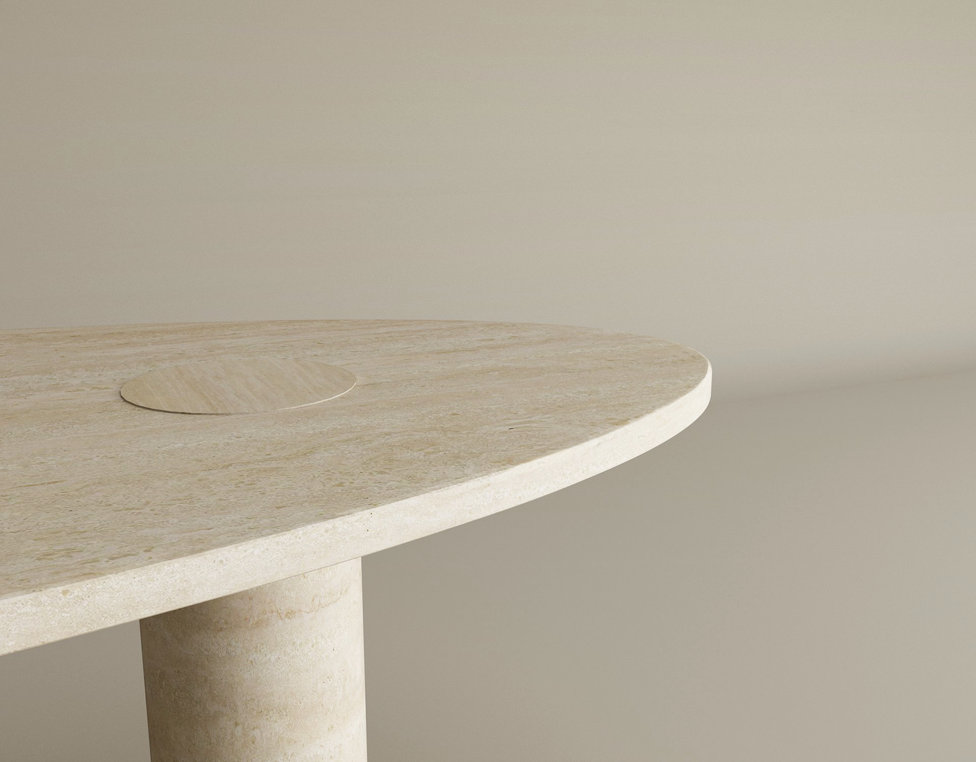 A close-up of the TRAVERTABLE Ellipse Travertine Coffee Table with Solid Cylindrical Base, featuring a light beige oval travertine top with natural veining and a matching circular detail, set against a plain beige background.