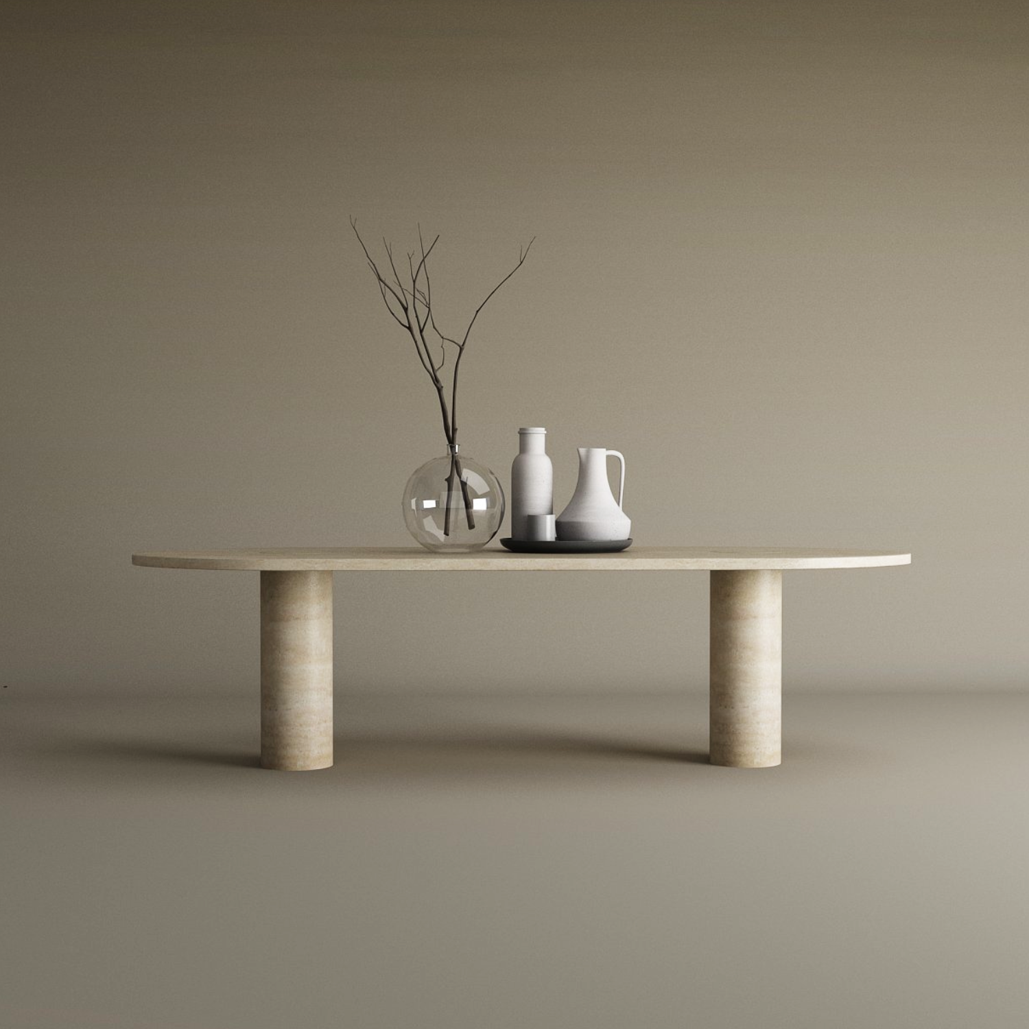 The TRAVERTABLE Oval Travertine Coffee Table, featuring a solid cylindrical base and warm veining, anchors the neutral setting with natural stone elegance. A clear vase with branches and ceramic vessels add minimalist charm to the beige background and floor.