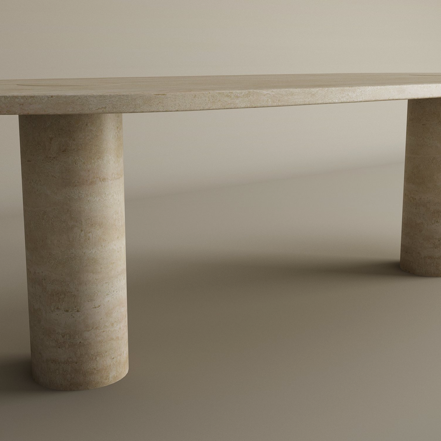 The TRAVERTABLE Oval Travertine Coffee Table features warm veining, a solid cylindrical base, and natural stone beauty, all set against a neutral background. Customizable to fit your style.