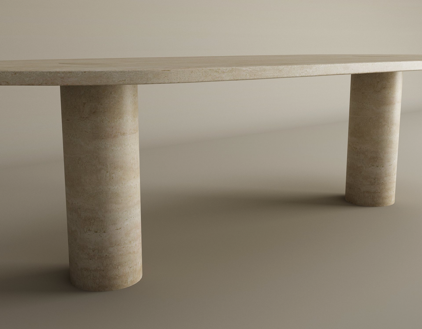 The TRAVERTABLE Oval Travertine Coffee Table features warm veining, a solid cylindrical base, and natural stone beauty, all set against a neutral background. Customizable to fit your style.