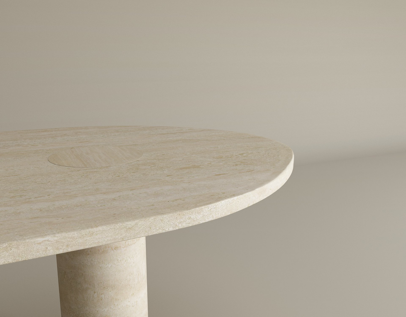 Close-up of the Oval Travertine Coffee Table with Solid Cylindrical Base by TRAVERTABLE, showing warm natural stone veining. Only part of this customizable table’s top and leg is visible, set against a beige background.