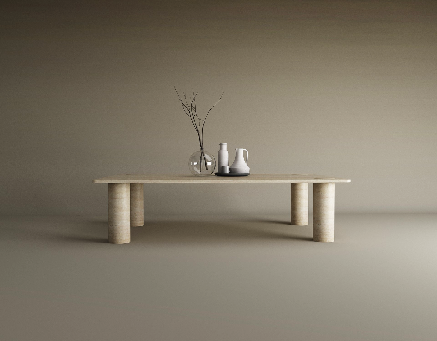 The TRAVERTABLE Rectangular Travertine Coffee Table with a solid cylindrical base displays three vases—glass, white, and black-and-white—with bare twigs, all set against a plain, neutral background.