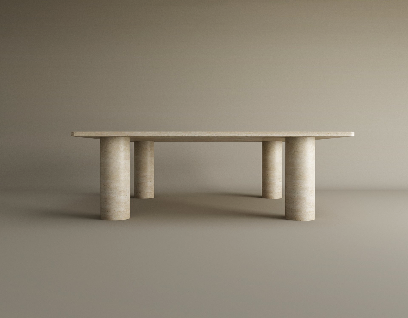 The TRAVERTABLE Rectangular Travertine Coffee Table features a warm travertine stone top and four solid cylindrical bases, showcased in an empty room with neutral beige walls and floor.