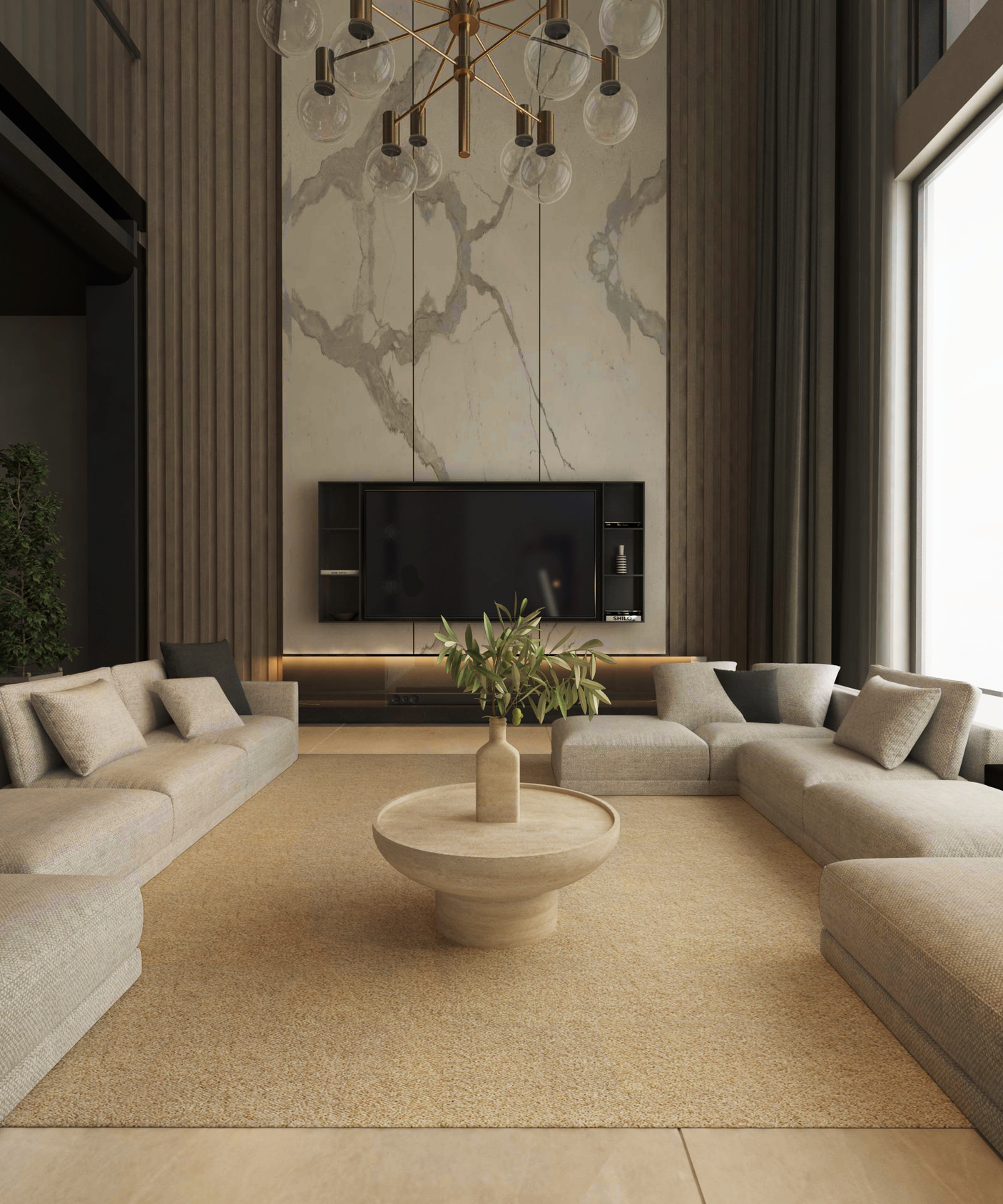 A modern living room features beige sectional sofas in a U-shape around the TRAVERTABLE Round Travertine Coffee Table with Solid Cylindrical Base on a tan rug, facing a large TV on a marble wall, with tall windows and a gold chandelier above.