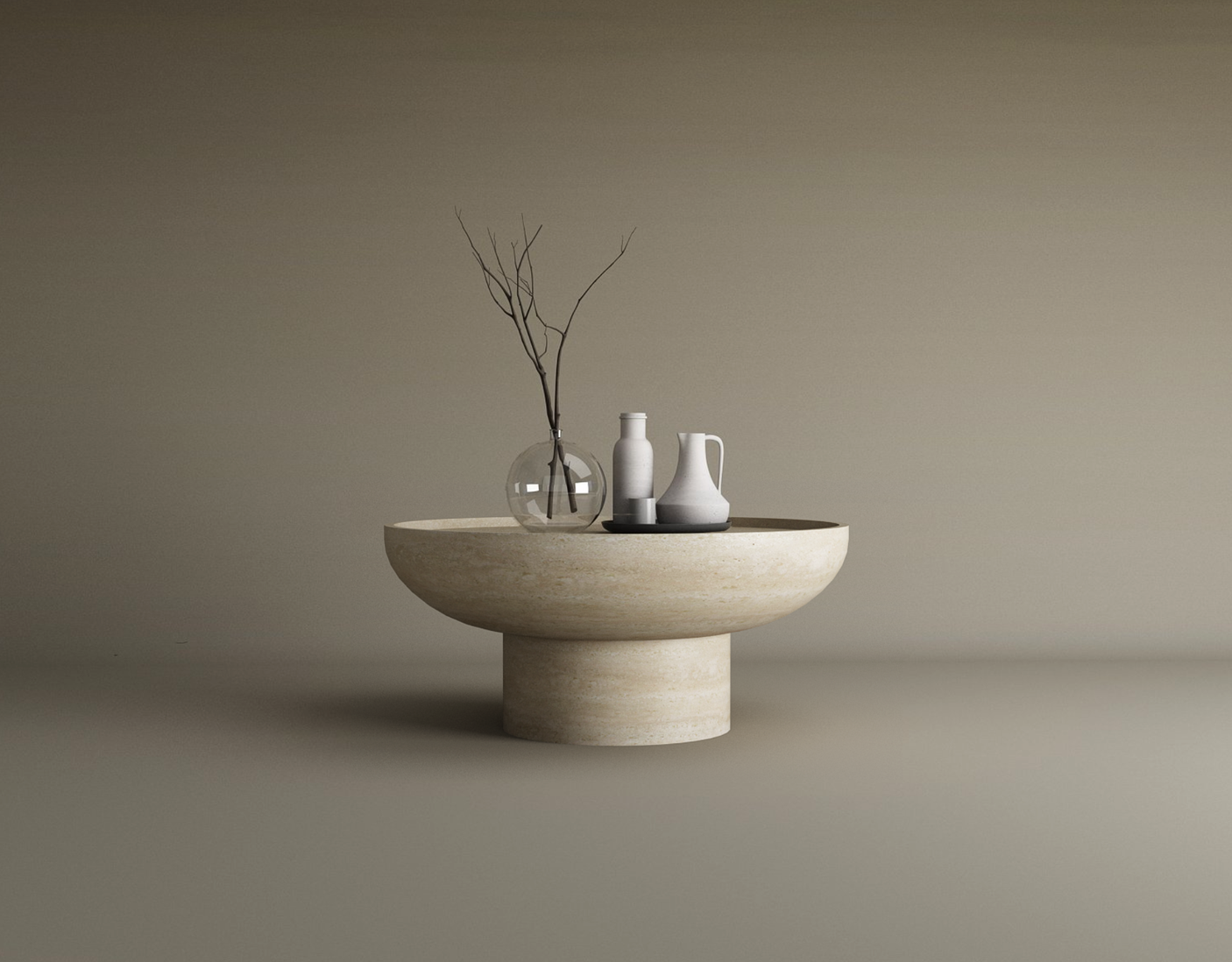 A beige Round Travertine Coffee Table with a solid cylindrical base by TRAVERTABLE is set against a neutral background and topped with a clear vase of branches, white bottle, vase, and pitcher for a perfect minimalist look.
