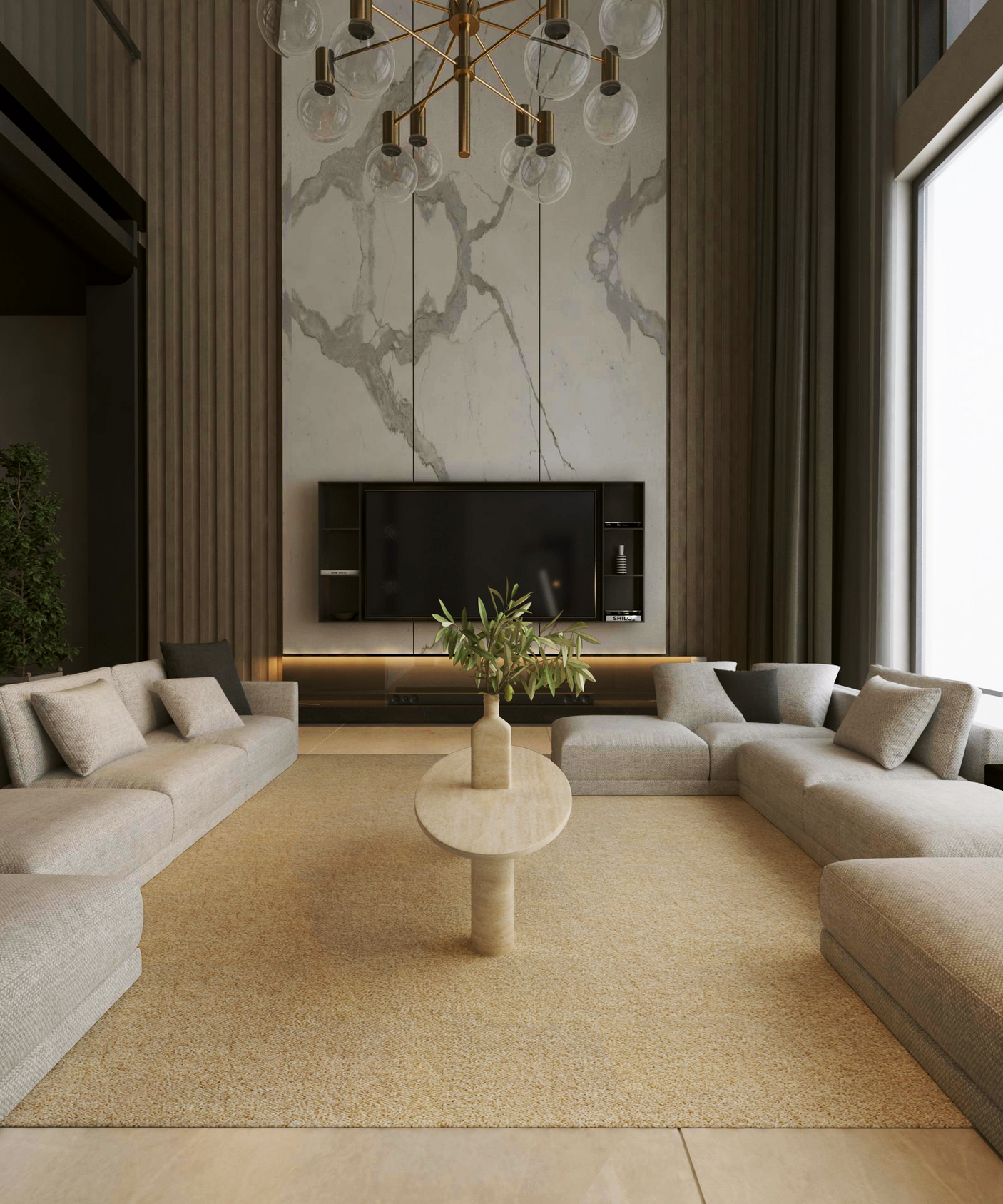 A modern living room with two large beige sectional sofas facing each other, a TRAVERTABLE Ellipse Travertine Coffee Table with Solid Cylindrical Base in the center, a marble accent wall with a mounted TV, and a large window letting in natural light.