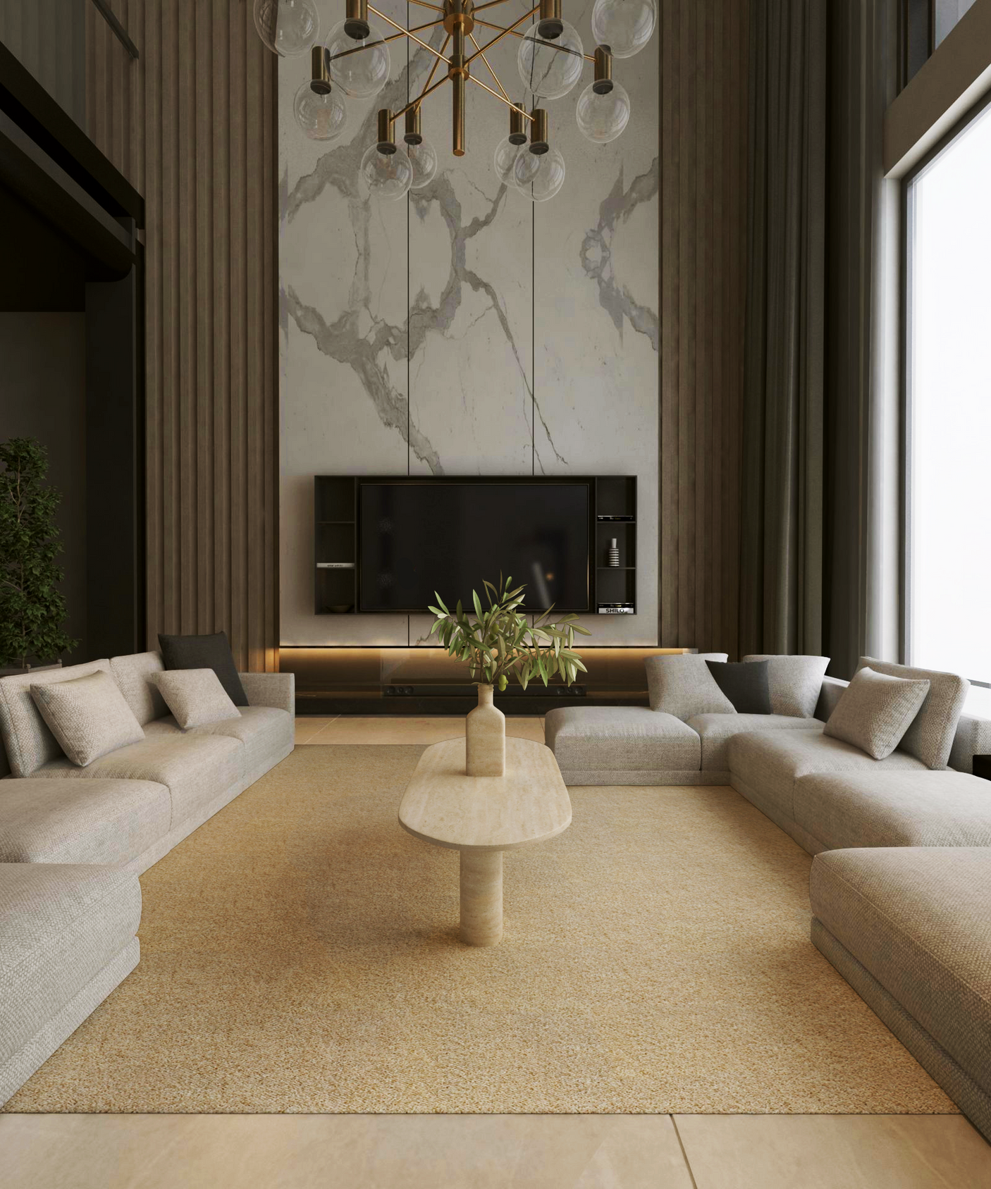 A modern living room features beige sectional sofas, a large flat-screen TV set against marble accents, and a gold chandelier. The TRAVERTABLE Oval Travertine Coffee Table with Solid Cylindrical Base adds natural elegance and warmth to the space.