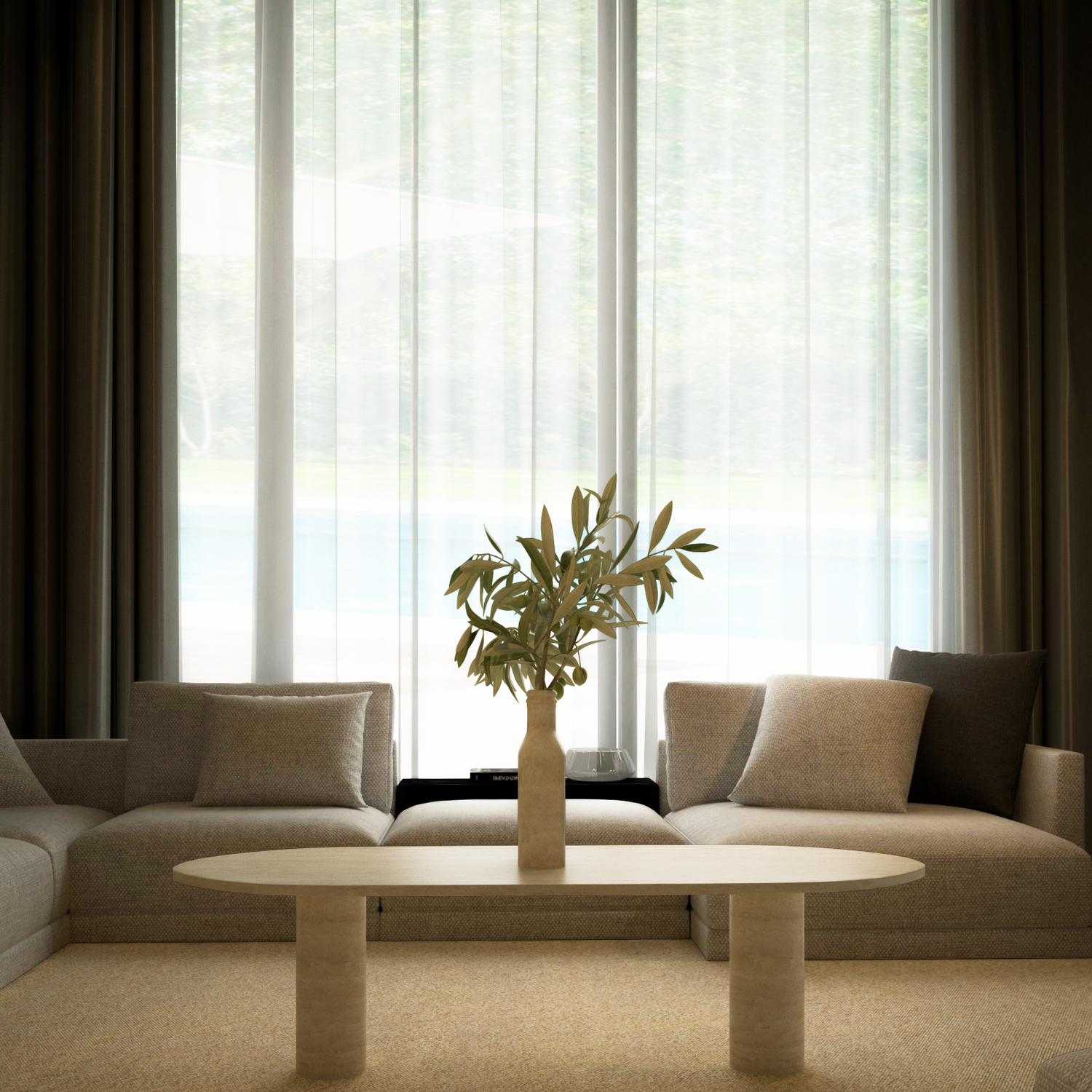 A modern living room with two beige sofas, an Oval Travertine Coffee Table with Solid Cylindrical Base by TRAVERTABLE, a beige carpet, and large windows with sheer curtains letting in natural light.