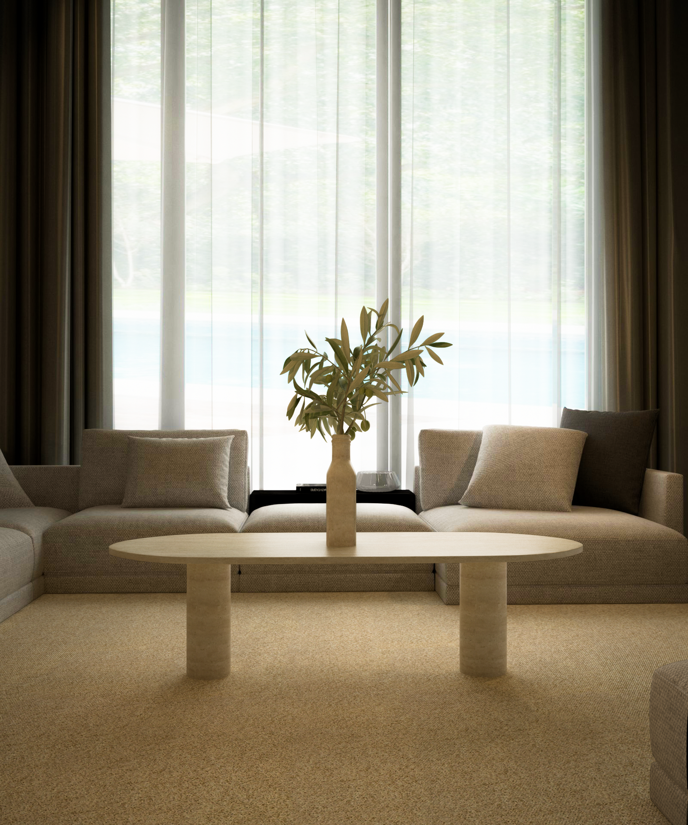 A modern living room with two beige sofas, an Oval Travertine Coffee Table with Solid Cylindrical Base by TRAVERTABLE, a beige carpet, and large windows with sheer curtains letting in natural light.