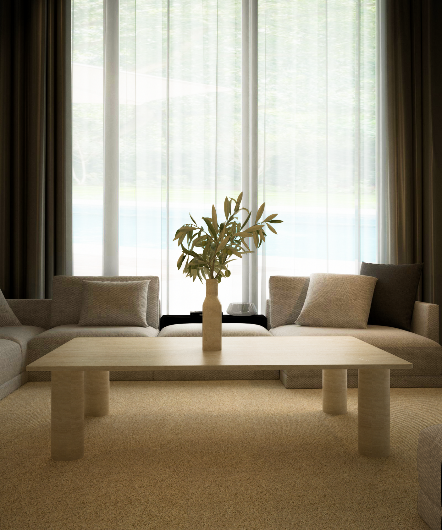 A minimalist living room with neutral sofas features the TRAVERTABLE Rectangular Travertine Coffee Table with Solid Cylindrical Base in warm stone, plus a vase of green branches. Sheer-curtained windows fill the space with light and frame lush outdoor greenery.