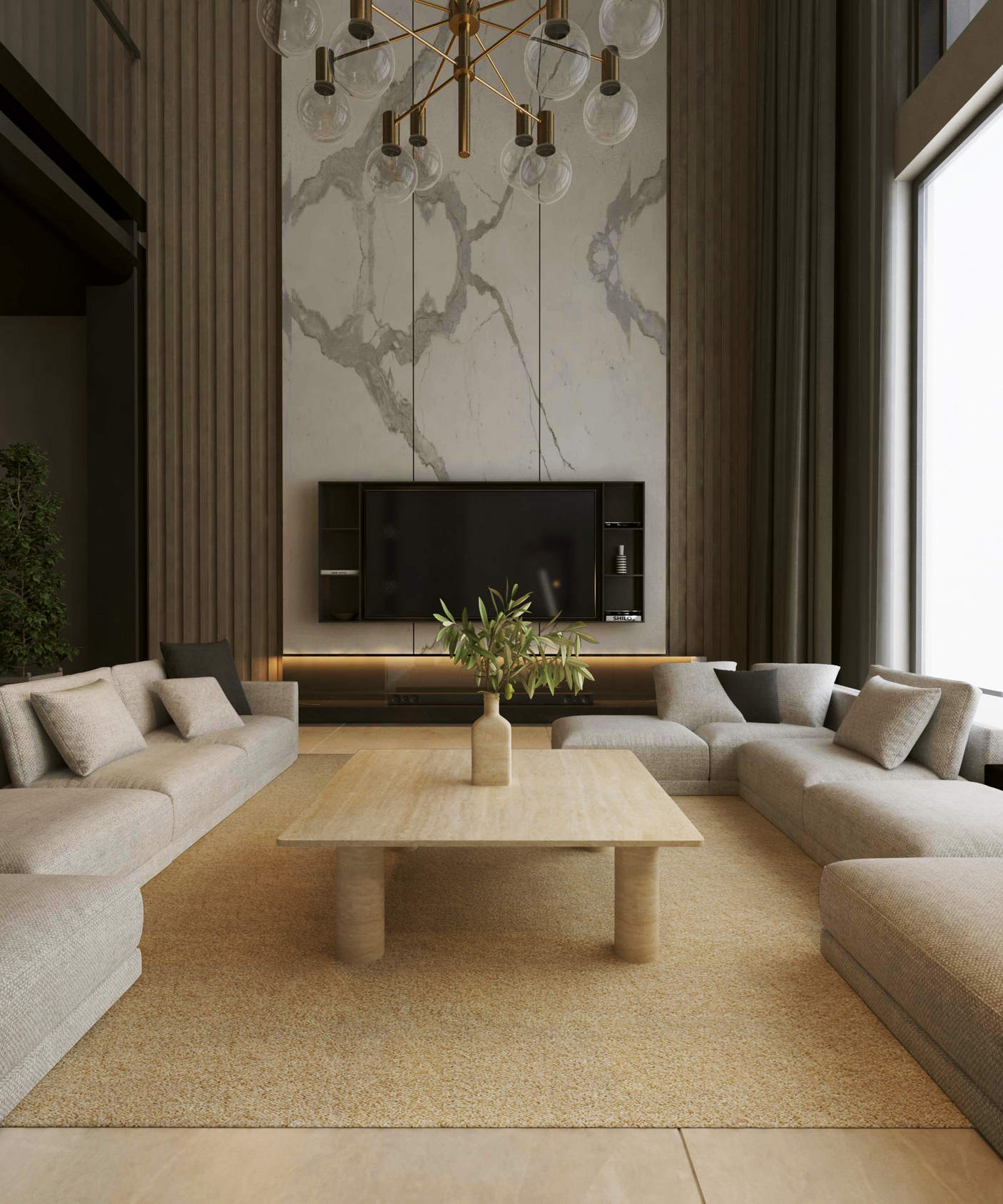A modern living room features beige sectional sofas in a U-shape around TRAVERTABLE’s Square Travertine Coffee Table with Solid Cylindrical Base, topped with a vase of greenery. A TV is mounted on a marble-accented wall, and a gold chandelier hangs overhead.