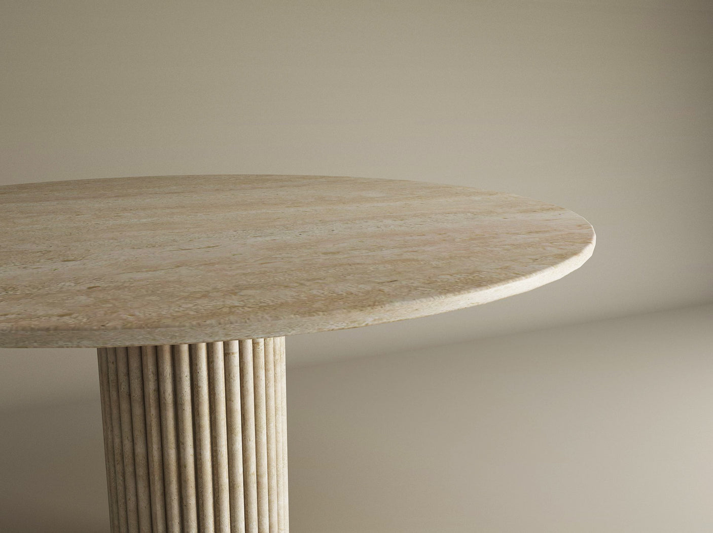 The TRAVERTABLE Oval Travertine Dining Table features a solid travertine stone top and fluted round center base, exuding natural elegance against a plain beige background. Customizable to fit your dining space.