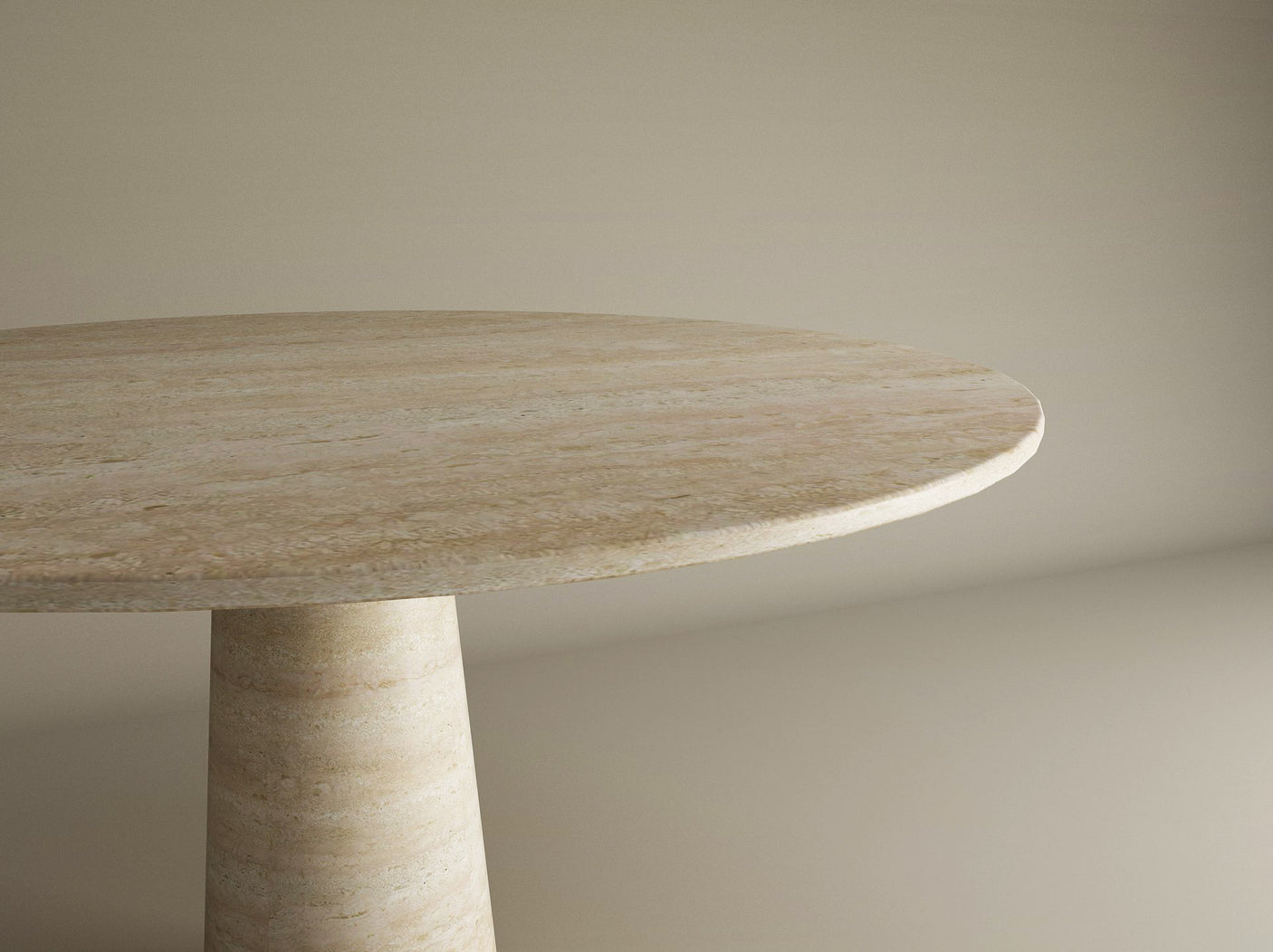 The image shows the TRAVERTABLE Oval Travertine Dining Table, featuring a conical center base and crafted from natural travertine stone. The tabletop and part of the base are pictured at an angle against a neutral background.