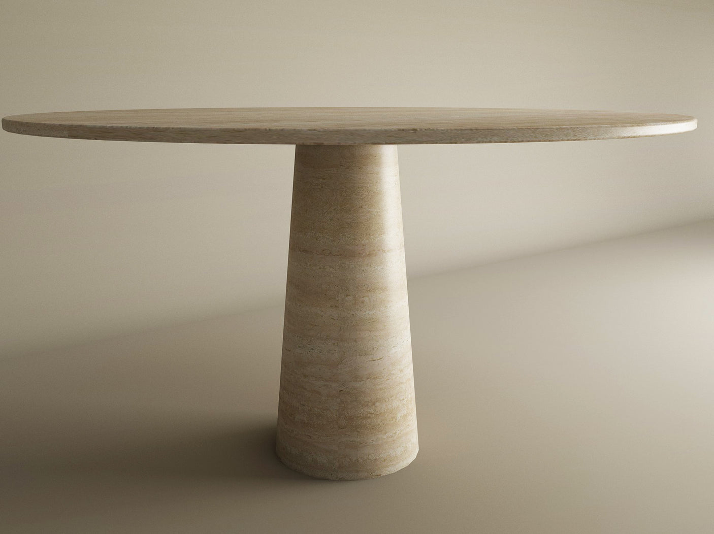 The TRAVERTABLE Oval Travertine Dining Table features a smooth, natural stone top and a single conical base, creating an elegant centerpiece in any neutral-toned room. This customizable table showcases timeless style and quality craftsmanship.