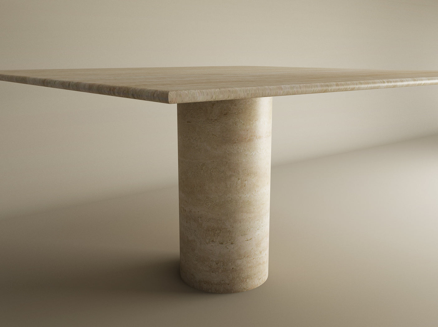 A softly lit neutral room shows part of the hand-finished Square Travertine Dining Table by TRAVERTABLE, featuring natural stone veining and a thick cylindrical center base in pure travertine stone.