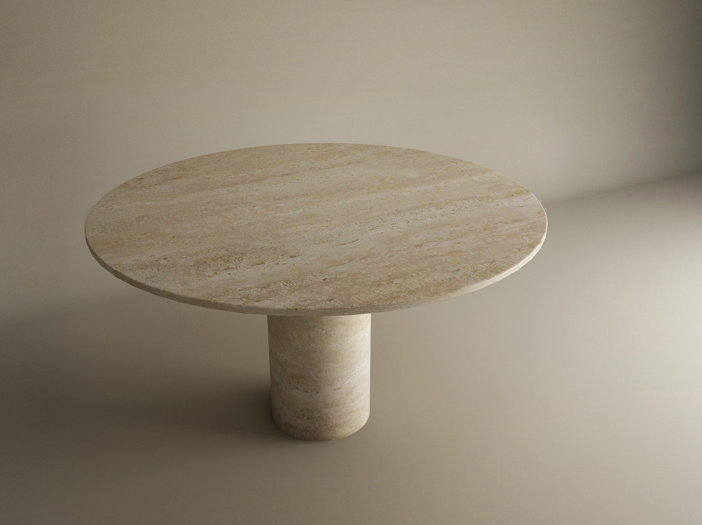 The TRAVERTABLE Oval Travertine Dining Table features a thick cylindrical center base and a smooth, beige pure travertine stone surface, elegantly displayed on a light-colored floor in a softly lit dining area.