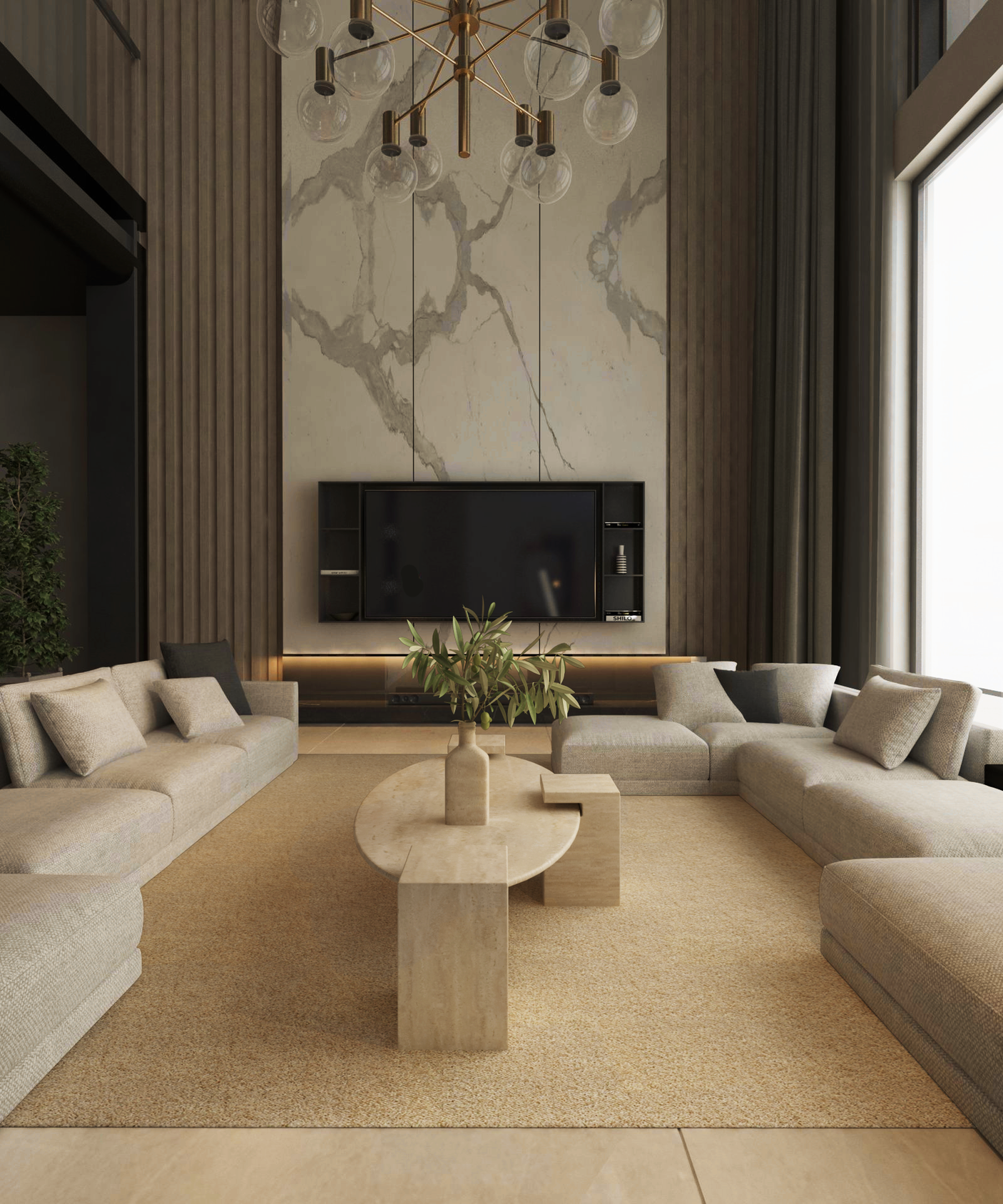 A modern living room features beige U-shaped sectional sofas around a TRAVERTABLE Ellipse Travertine Coffee Table with Square Base. A large TV sits on a marble accent wall, shelves below, with tall windows and a gold chandelier brightening the space.
