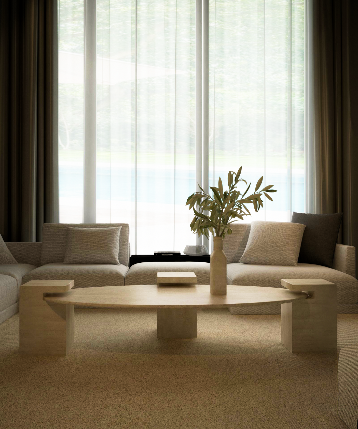A modern living room features a beige sectional, TRAVERTABLE’s customizable Ellipse Travertine Coffee Table with Square Base, and a vase with green branches. Sheer curtains on tall windows let in soft light, highlighting the timeless neutral decor.