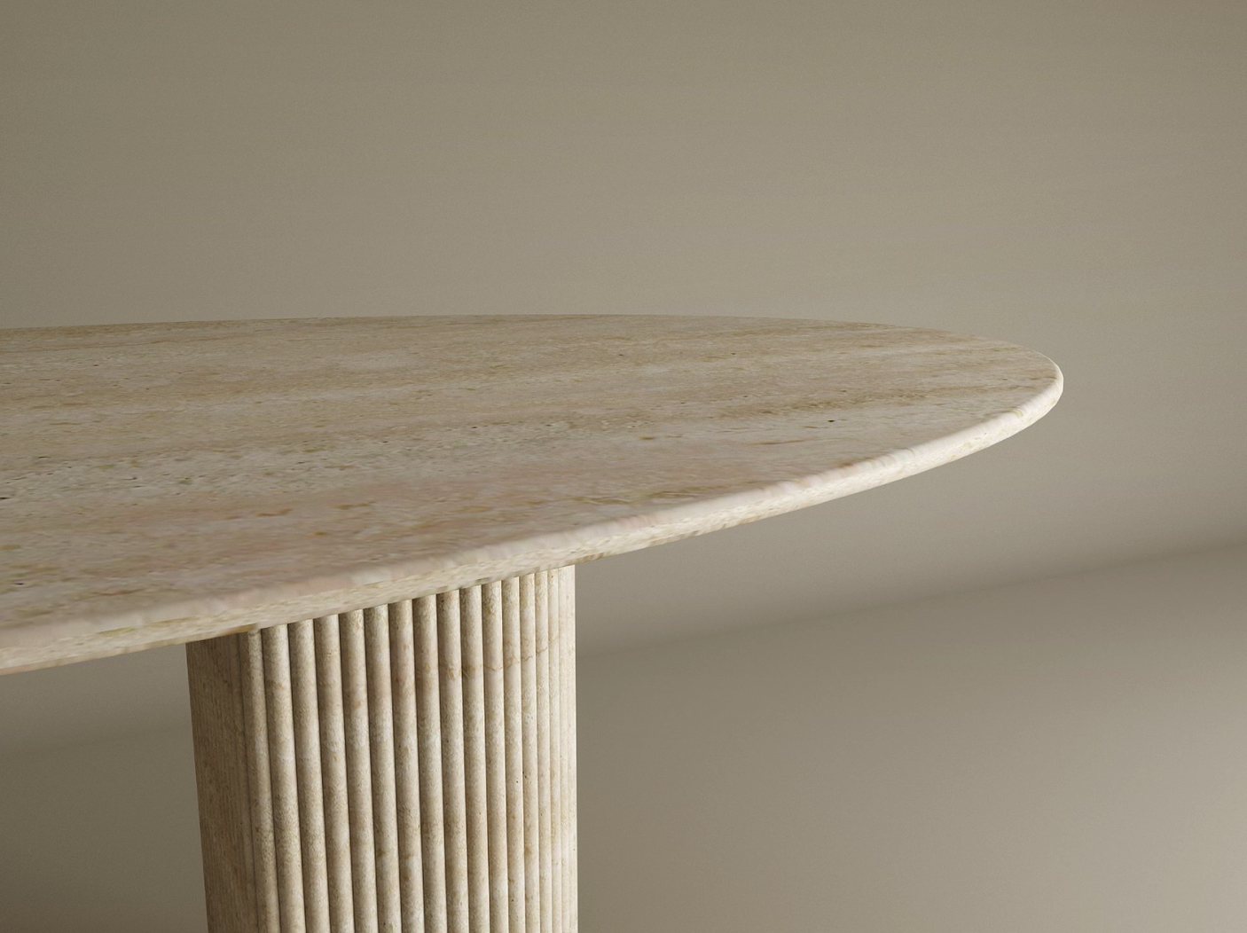 A close-up of the TRAVERTABLE Ellips Travertine Dining Table, featuring a natural solid travertine stone tabletop with rounded edge and a single fluted round base, shown against a plain neutral background.