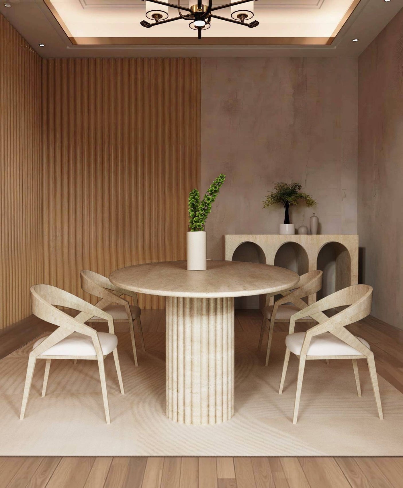 A modern dining room featuring the TRAVERTABLE Ellips Travertine Dining Table with a fluted round solid travertine stone base, four wooden chairs, wood-paneled and beige walls, a sideboard with vases and greenery, wooden floors, and a ceiling light fixture.