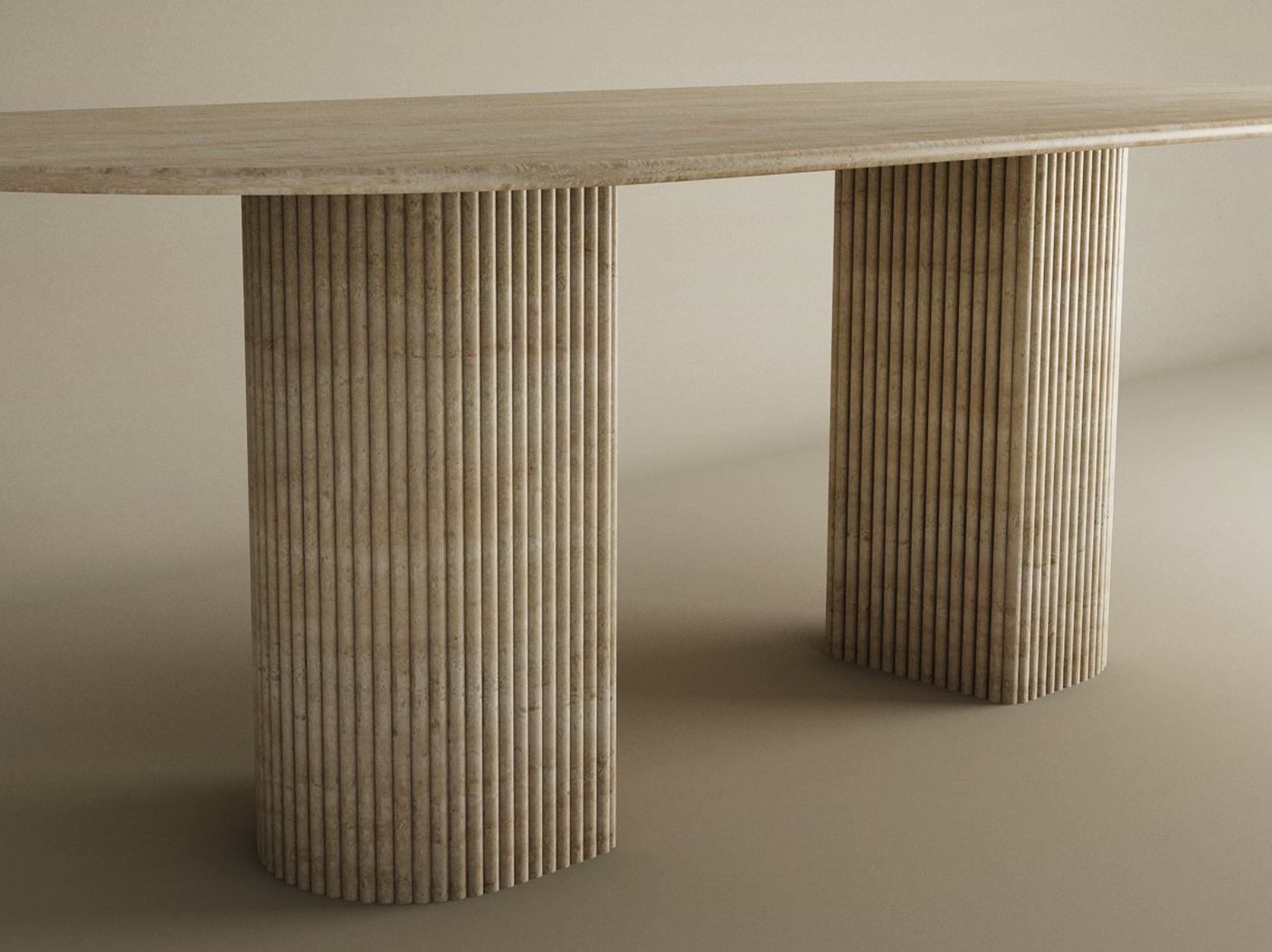 The TRAVERTABLE Oval Travertine Dining Table features a fluted round solid stone base and a customizable beige textured travertine top. Shown against a plain, neutral background.
