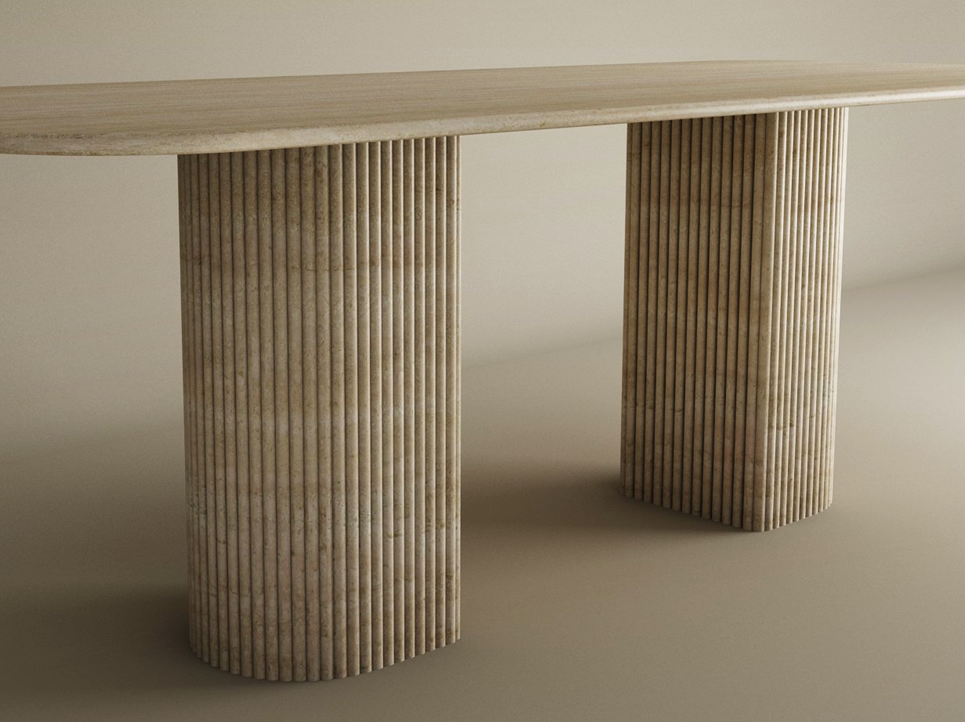 The TRAVERTABLE Rectangular Travertine Dining Table features a smooth travertine top and two fluted round solid stone bases, offering heirloom quality craftsmanship in a customizable, neutral-toned design.