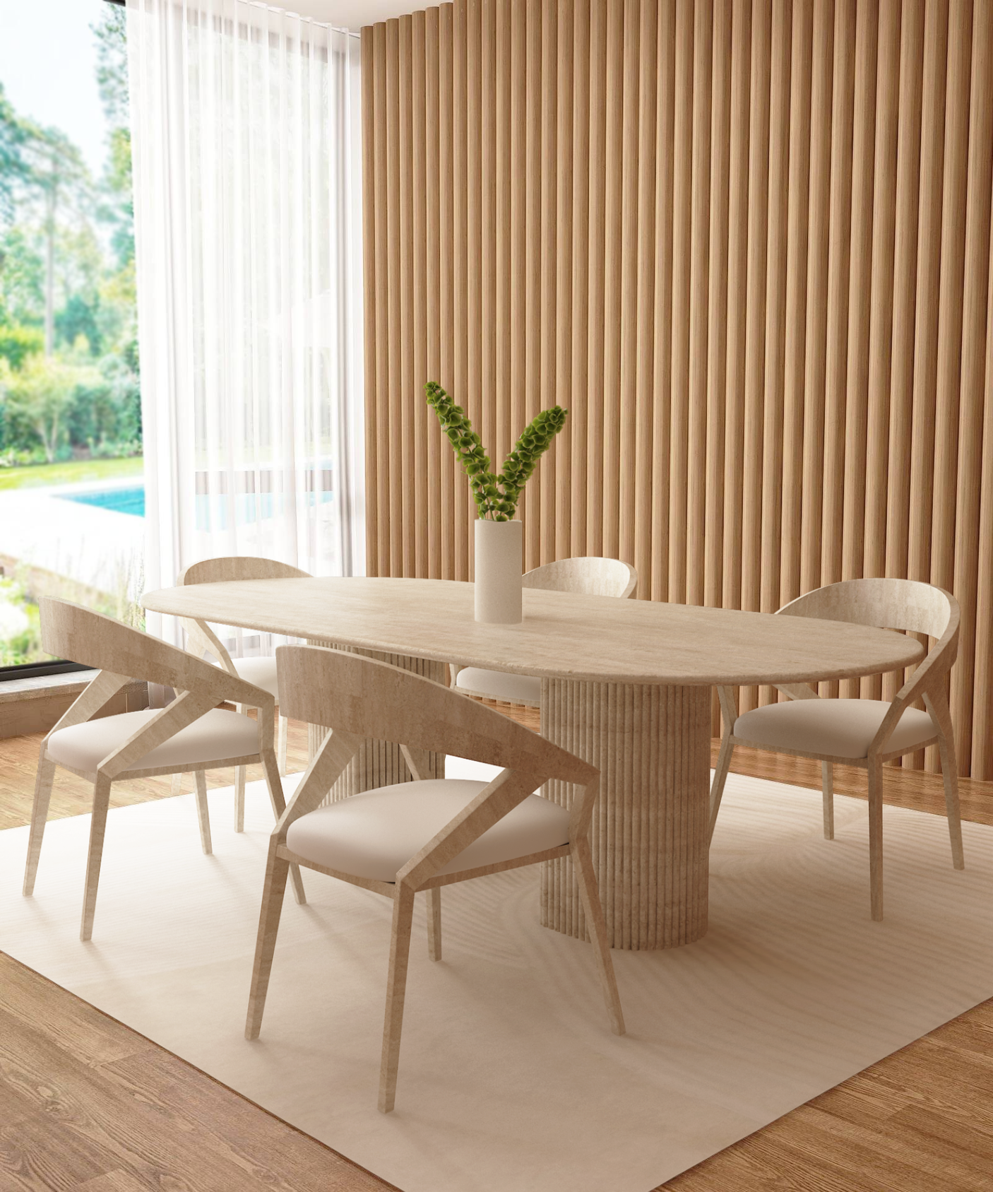 A modern dining room features the TRAVERTABLE Oval Travertine Dining Table with a fluted round stone base, four matching chairs, a neutral rug, and a tall vase with green stems. Vertical wood slats accent one wall; large windows overlook trees and an outdoor pool.