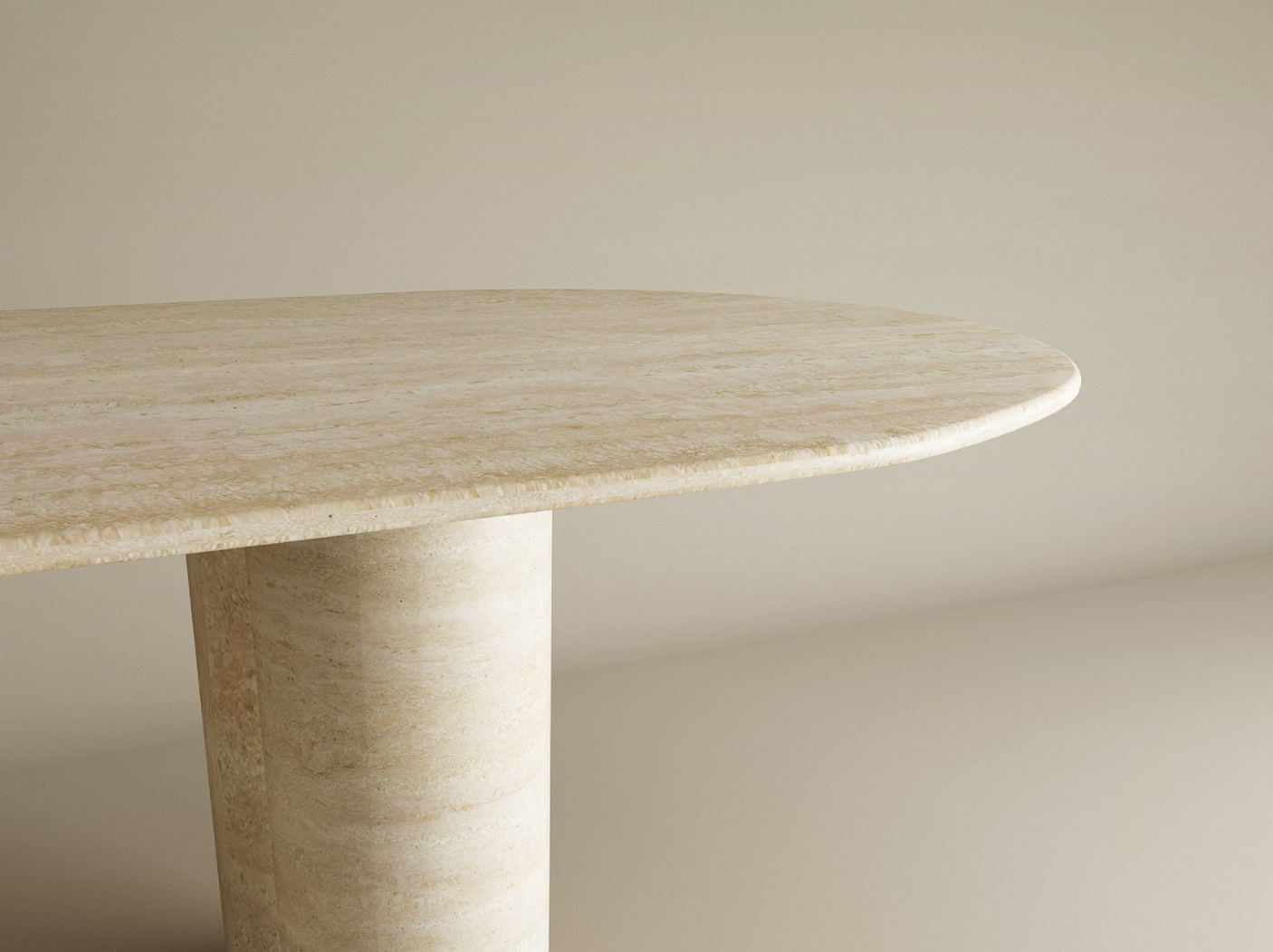 A close-up of the TRAVERTABLE Oval Travertine Dining Table featuring a light beige natural stone top and a cylindrical pure travertine base, set against a matching background. Customizable options available.