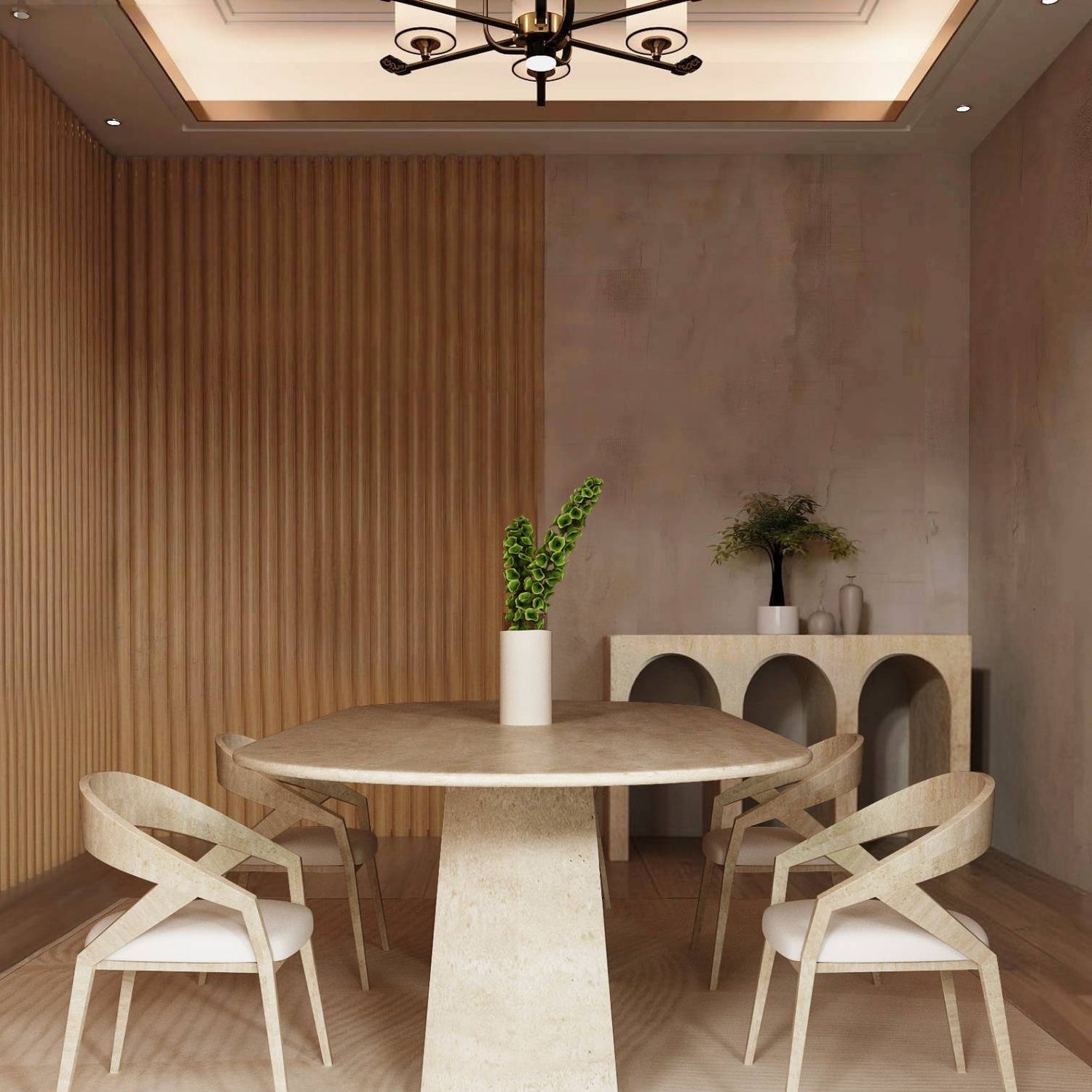 A modern dining room featuring the TRAVERTABLE Oval Travertine Dining Table with a solid stone base, four matching chairs, a light rug, green-leaf vase centerpiece, wood accent wall, and console table with decor against a beige wall.