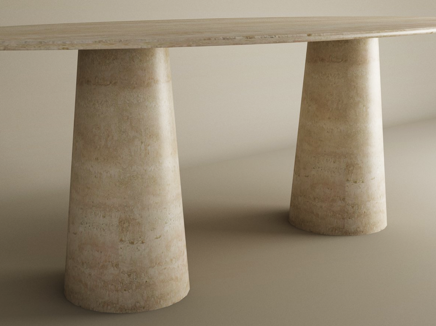 A close-up of the TRAVERTABLE Ellips Travertine Dining Table, featuring an oval top and two wide conical stone bases with a smooth finish—customizable, unique home furniture crafted from organic travertine.