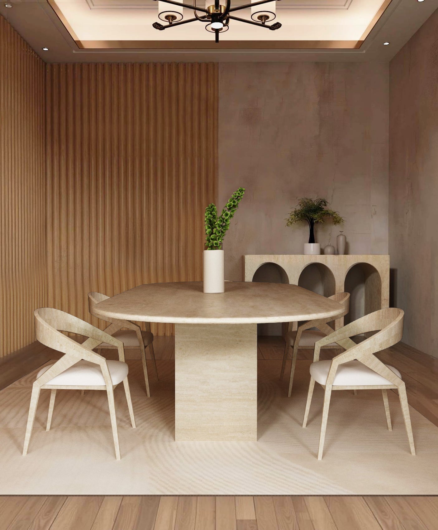 A minimalist dining room features the TRAVERTABLE Oval Travertine Dining Table with a natural stone block base, four matching chairs, a white vase with green stems, wood panel walls, and a sideboard with decorative vases and greenery.