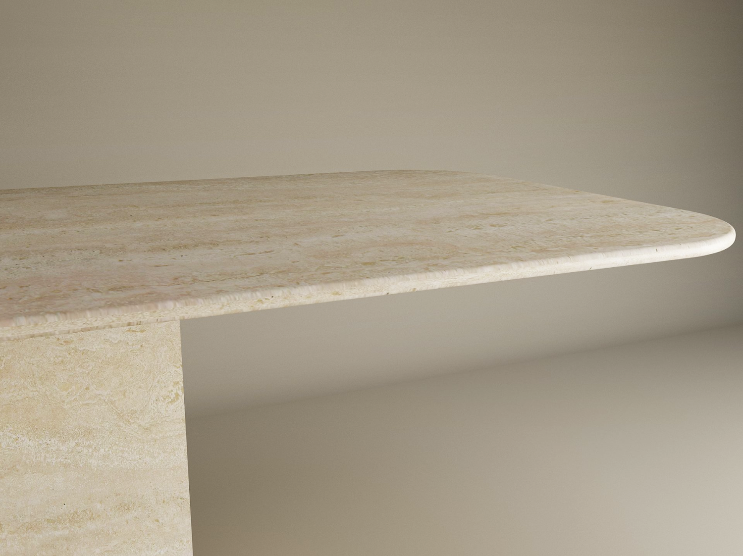 A close-up of the TRAVERTABLE Rectangular Travertine Dining Table with Block Base shows its thick natural stone top, rounded edges, and sturdy base, set against a plain background. Customizable design by TRAVERTABLE.