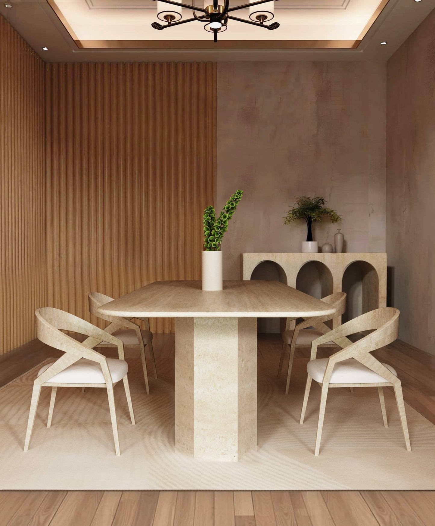 A modern dining room featuring the TRAVERTABLE Rectangular Travertine Dining Table with Hexagonal Pedestal Base and organic stone, four white-cushioned chairs, a white vase with green leaves, wooden slat wall, and a decor-adorned sideboard.