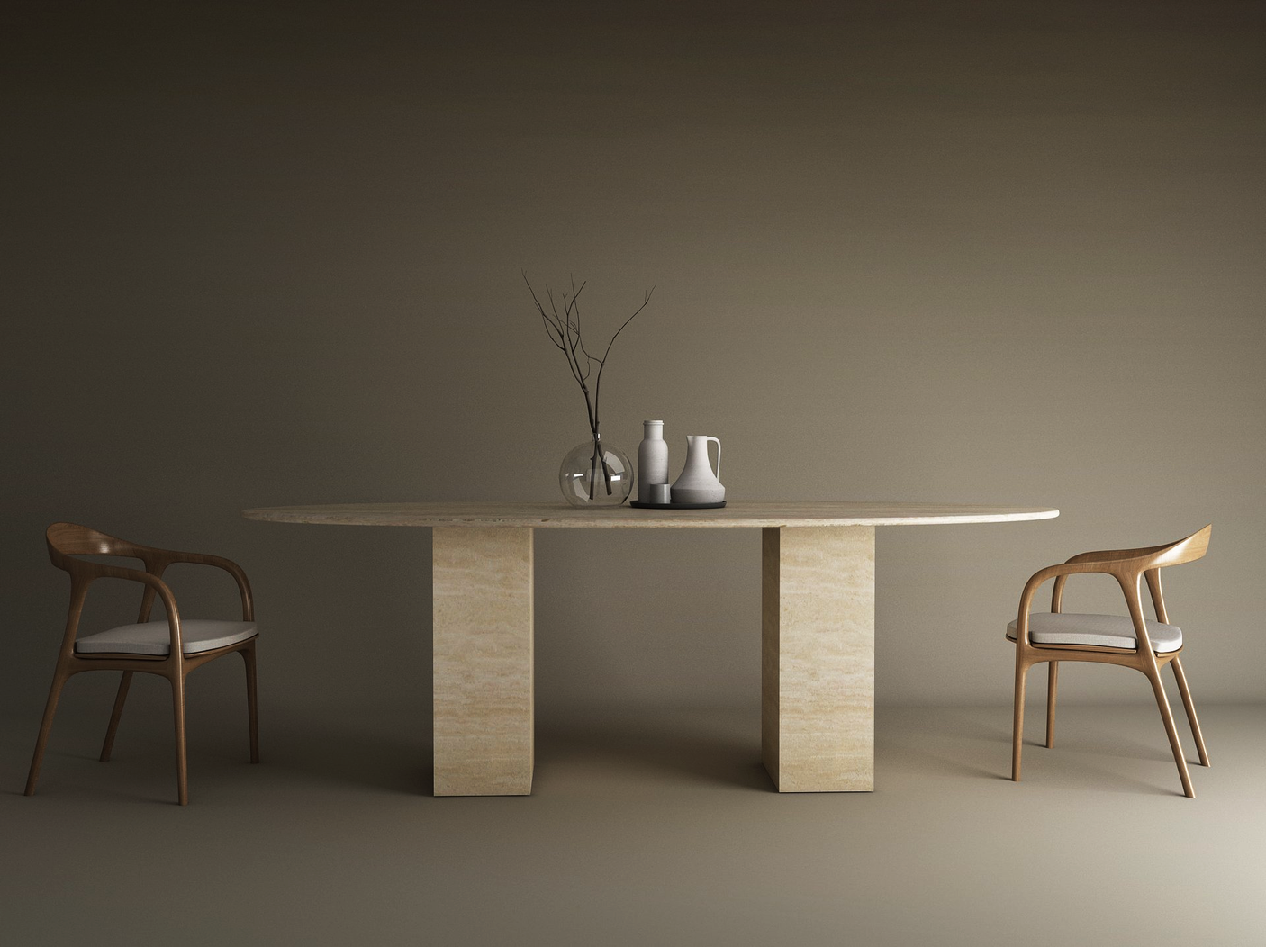 A minimalist dining setup with the TRAVERTABLE Ellips Travertine Dining Table featuring a travertine stone base, two wooden chairs with white cushions, and neutral-toned vases and a bare branch centerpiece against a plain background.
